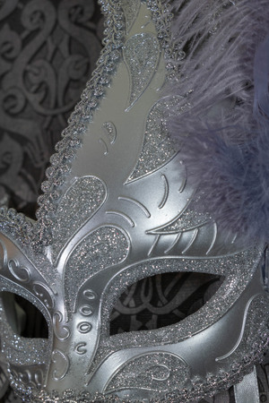 silver carnival mask with purple featherの写真素材