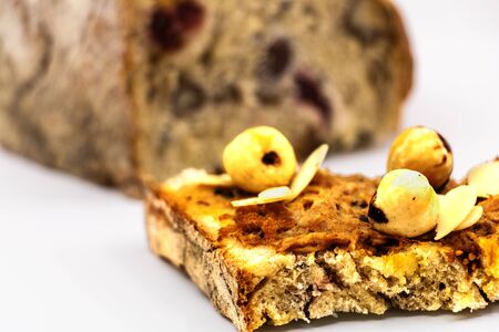 Slice of bread and chicken ricotta with whole nuts and almonds slice of bread with cereals and dried fruit background with bread loaf complete- isolated white background studioの写真素材