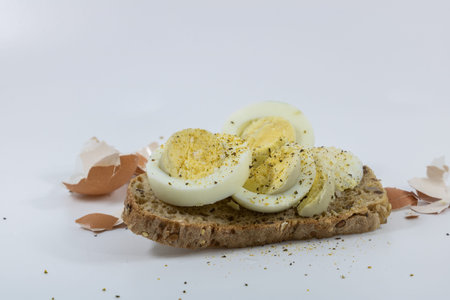 Sandwich with boiled eggs and spices on a white background, isolated