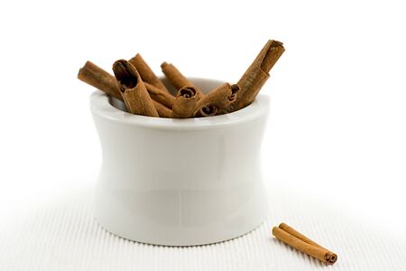 bunch of cinnamon bark in mortarの写真素材