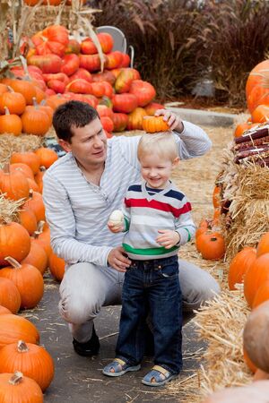 happy father and son at the pumpkin patchの写真素材