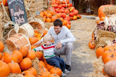 happy father and son at the pumpkin patchの写真素材