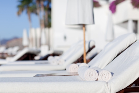 empty white sunbeds at the modern resortの写真素材