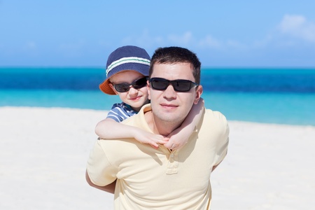 family of two hugging at the perfect caribbean beach, focus on the childの写真素材