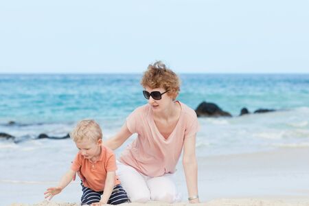young mother and her son at the tropical hawaiian beachの写真素材