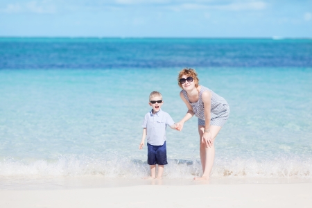 happy family of two at the perfect caribbean beachの写真素材