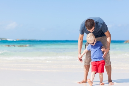 handsome father and his son at the caribbean beachの写真素材