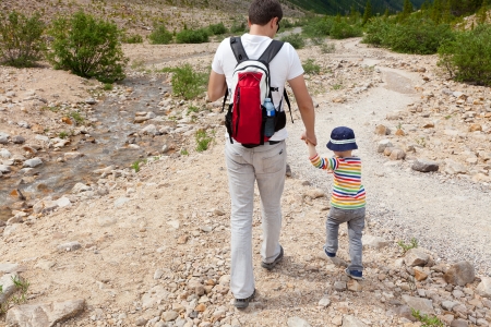 young caucasian father and his son hiking in jasper national park, canada; happy family of two having fun outdoorsの写真素材