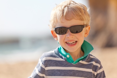 smiling adorable boy enjoying summer time at the beachの写真素材