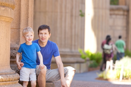 young handsome father and his adorable son spending time together during summer city vacationの写真素材