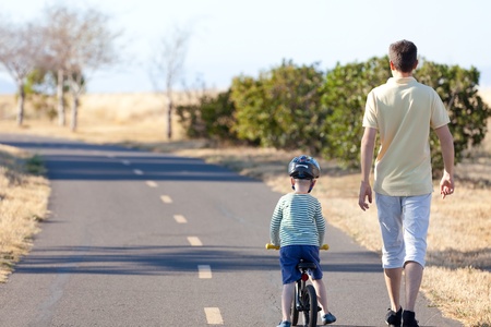 little boy and his father having a nice walk together at summerの写真素材