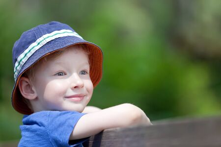 cute smiling boy in a sunhat outdoorsの写真素材