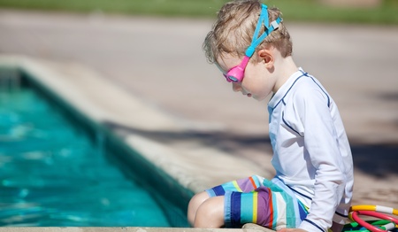 cute little boy concentrating before swimming trainingの写真素材