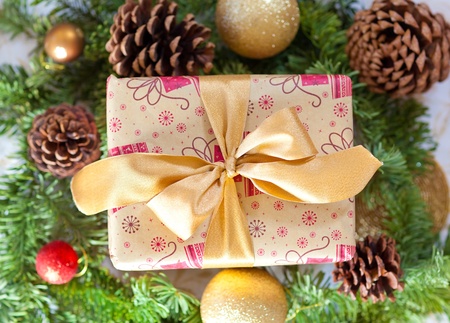 nicely wrapped christmas present with a golden bowの写真素材
