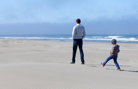family of two spending time in sand dunes at bandon, oregon, usaの写真素材