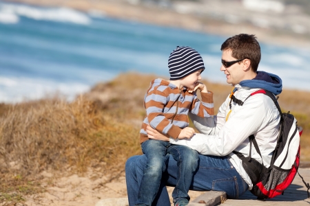 family of young happy father and cute laughing boy at the beach in california, usaの写真素材