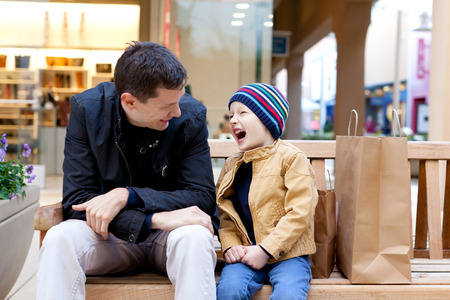 cheerful smiling family of two shopping togetherの写真素材