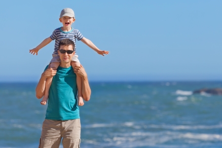 happy cheerful family of two spending fun time together by the seaの写真素材