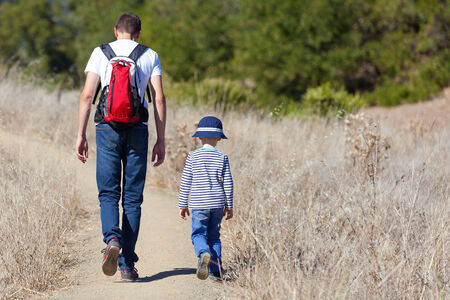 family of two walking outside togetherの写真素材