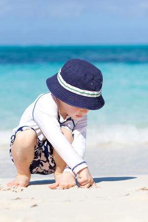 cute little boy at perfect caribbean beachの写真素材
