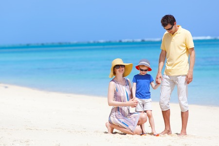 family of three at the tropical beachの写真素材
