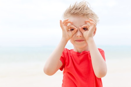 little boy having fun at the beachの写真素材