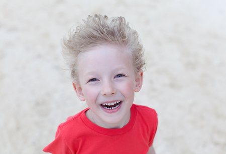 excited laughing boy at the beachの写真素材