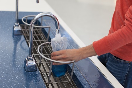 person refilling bottle with drinking water, save the planet conceptの写真素材