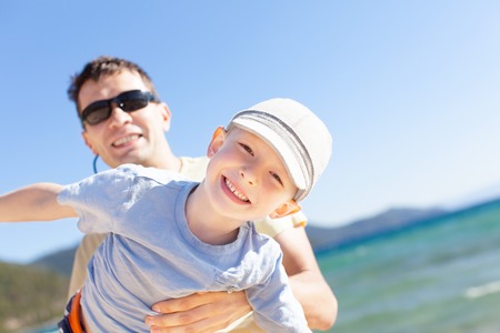 cheerful family of two having fun during vacation at lake tahoe, california, usaの写真素材