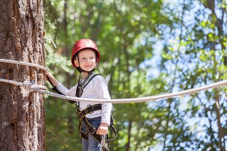 brave little boy climbing at adventure parkの写真素材