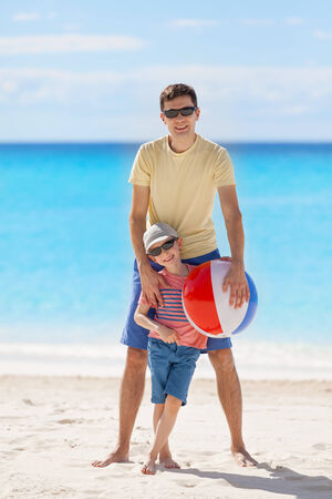 family of two enjoying vacation time together at the caribbean beachの写真素材