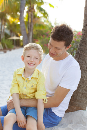 family of two enjoying vacation time together at the beachの写真素材