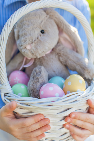 close-up of easter basket with colorful eggs and bunny at spring timeの写真素材
