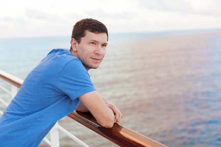 young handsome man enjoying vacation at cruise shipの写真素材