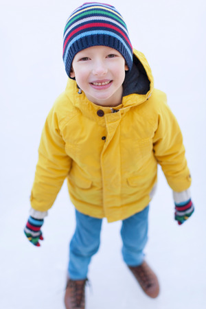 little boy enjoying ice skating at winter at outdoor skating rinkの写真素材