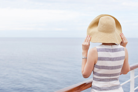 back view of young woman at cruise shipの写真素材