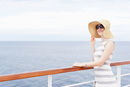 young smiling woman enjoying vacation at cruise shipの写真素材