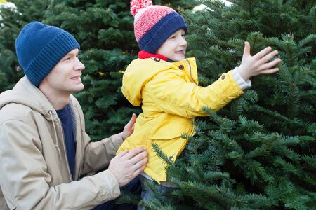 little smiling boy and his father shopping for christmas treeの写真素材