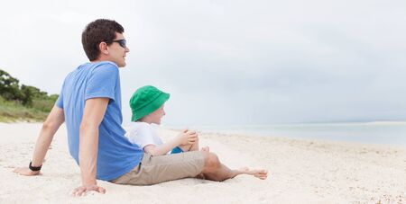 panorama of family of two enjoying kondoi beach at taketomi island, okinawa, japanの写真素材