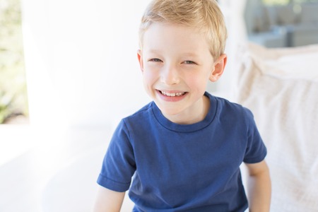 portrait of beautiful smiling boy expressing positive emotions relaxing during vacationの写真素材