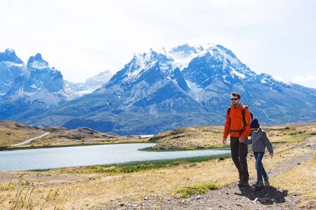 family of two, father and son, enjoying hiking in torres del paine national park, patagonia, chileの写真素材
