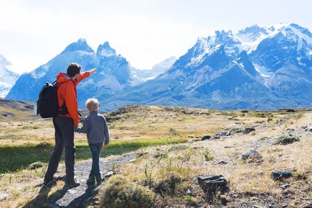 family of two, father and son, enjoying hiking in torres del paine national park, patagonia, chileの写真素材