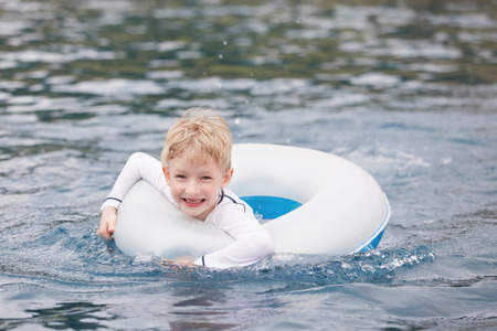 cheerful boy enjoying fun time in the poolの写真素材