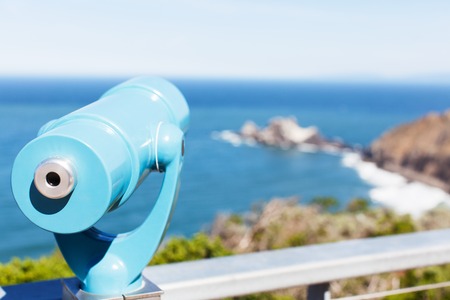 binoculars overlooking gorgeous rocky seashoreの写真素材