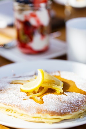 close-up of delicious ricotta pancakes with lemon jam for breakfast with yogurt granola in the...