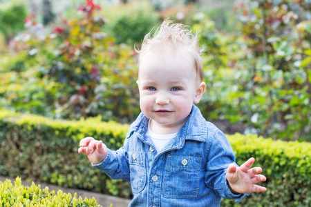 beautiful toddler boy looking straight enjoying springtime at the parkの写真素材