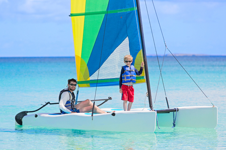 family of two, father and son, enjoying sailing together at hobie cat catamaran, active healthy lifestyleの写真素材