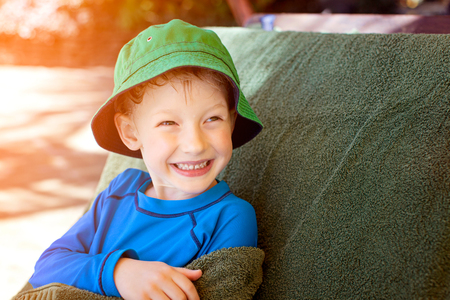 excited laughing kid enjoying summer vacation by the poolの写真素材