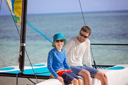 family of two, father and son, enjoying sailing together at hobie cat catamaran, active healthy lifestyle conceptの写真素材