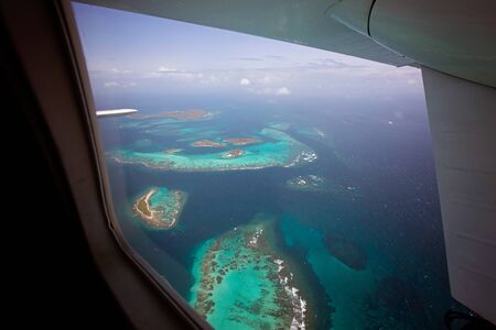 aerial view from the plane window of secluded tobago cays marine park, located in st vincent and the grenadines, beautiful island archipelago in caribbean seaの写真素材